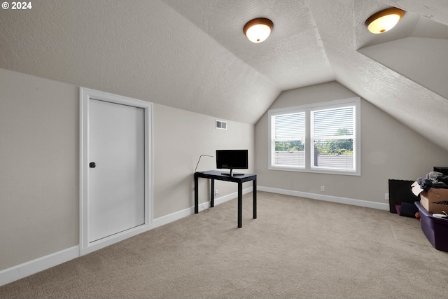 bonus room with a textured ceiling