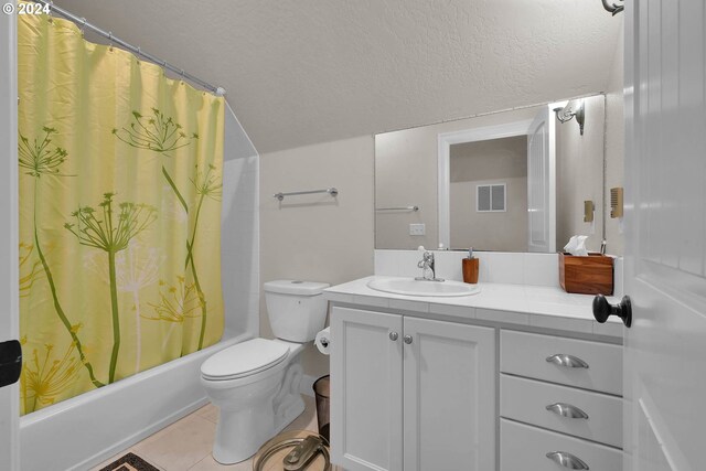 full bathroom with tile patterned flooring, toilet, shower / bath combination with curtain, vanity, and a textured ceiling