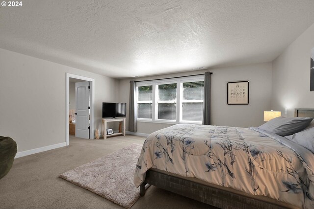 carpeted bedroom featuring a textured ceiling