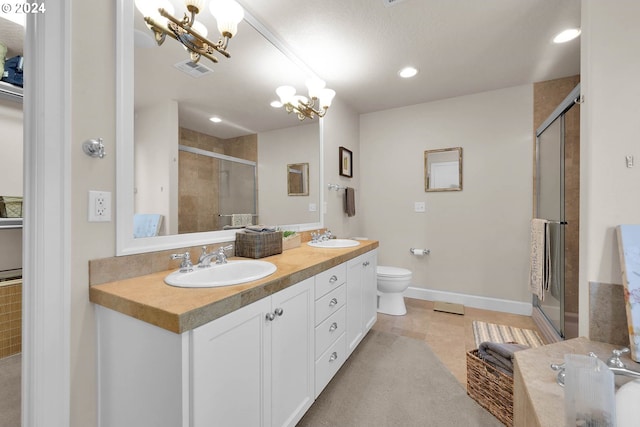 bathroom with toilet, a shower with door, a notable chandelier, and vanity