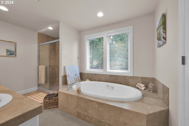 bathroom with vanity and separate shower and tub