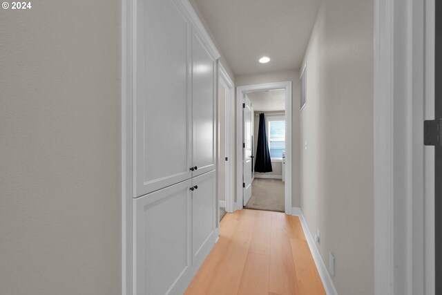 hallway with light hardwood / wood-style flooring