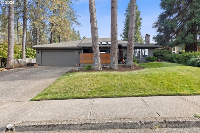 single story home featuring a garage and a front lawn