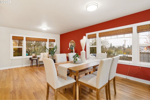 dining space with plenty of natural light and light wood-type flooring