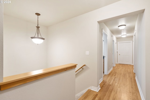 hallway with light hardwood / wood-style floors