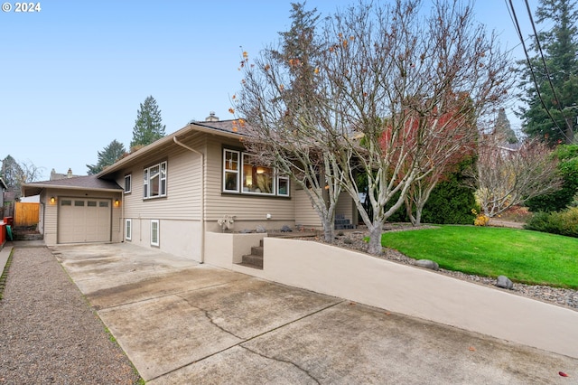 view of front of home with a front lawn and a garage