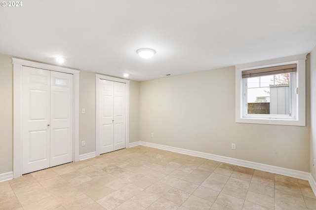 unfurnished bedroom featuring multiple closets