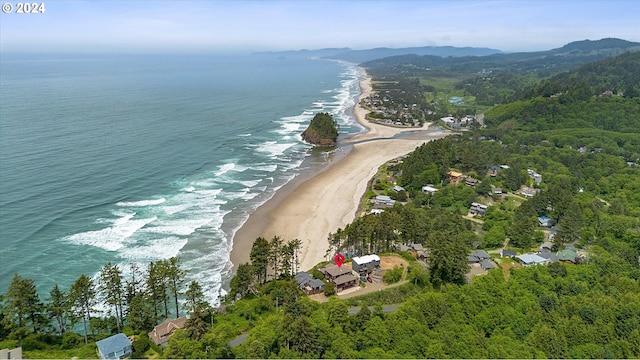 birds eye view of property featuring a view of the beach and a water and mountain view