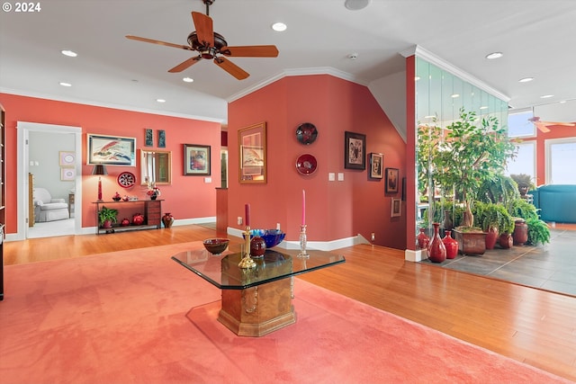 interior space with ceiling fan, recessed lighting, baseboards, wood finished floors, and ornamental molding