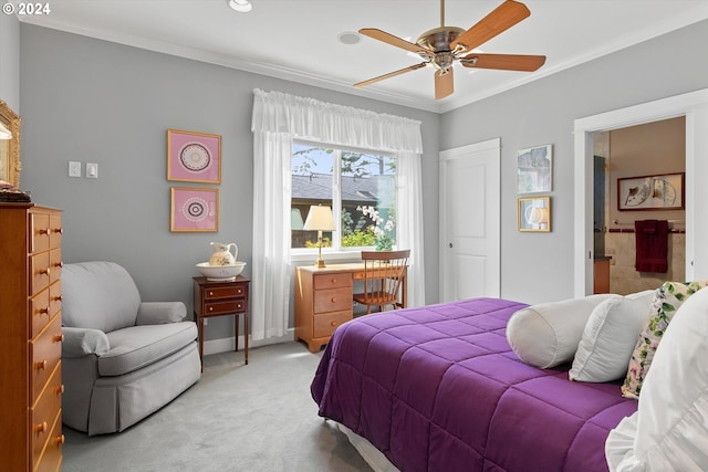 bedroom featuring light carpet, ensuite bath, a ceiling fan, baseboards, and ornamental molding
