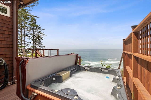 wooden terrace with a water view and a hot tub
