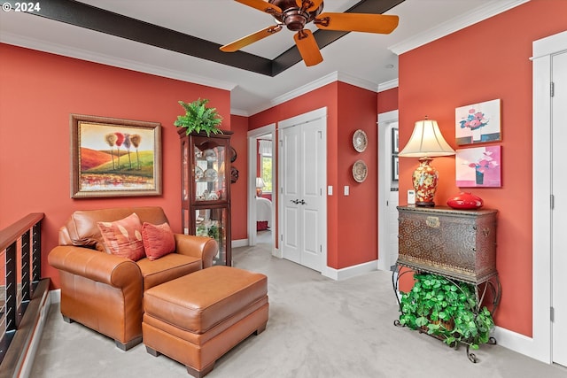 sitting room with crown molding, baseboards, ceiling fan, and carpet flooring