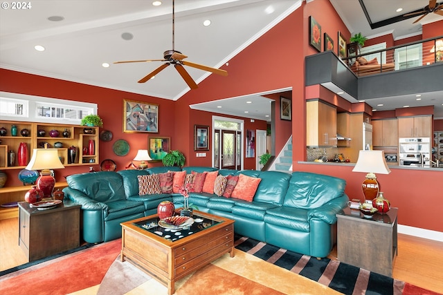 living area with crown molding, a ceiling fan, high vaulted ceiling, and recessed lighting