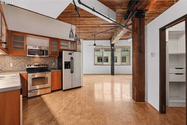 kitchen featuring decorative light fixtures, sink, backsplash, and stainless steel appliances