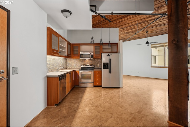 kitchen featuring stainless steel appliances, sink, ceiling fan, and tasteful backsplash