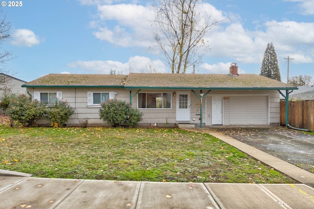 single story home with a front yard and a garage