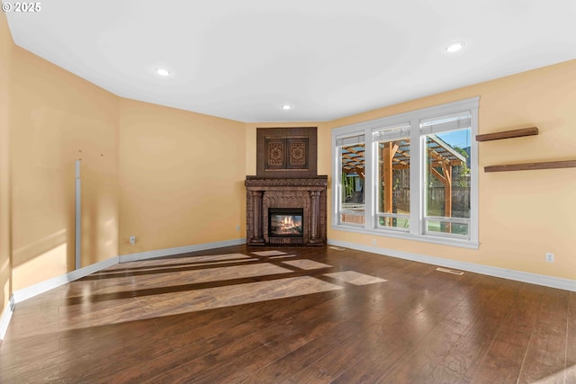 unfurnished living room with a fireplace and hardwood / wood-style floors