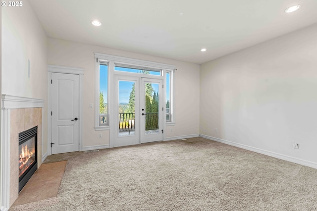 unfurnished living room with light carpet and french doors