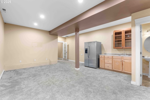 kitchen featuring light colored carpet, stainless steel fridge with ice dispenser, and sink