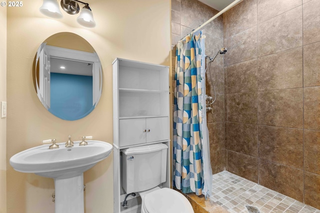 bathroom featuring curtained shower and toilet