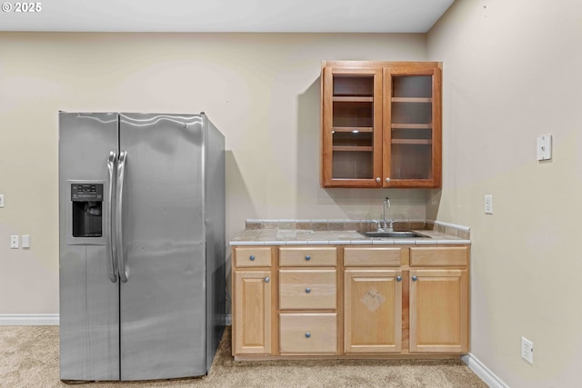 kitchen with stainless steel fridge with ice dispenser, sink, and light colored carpet