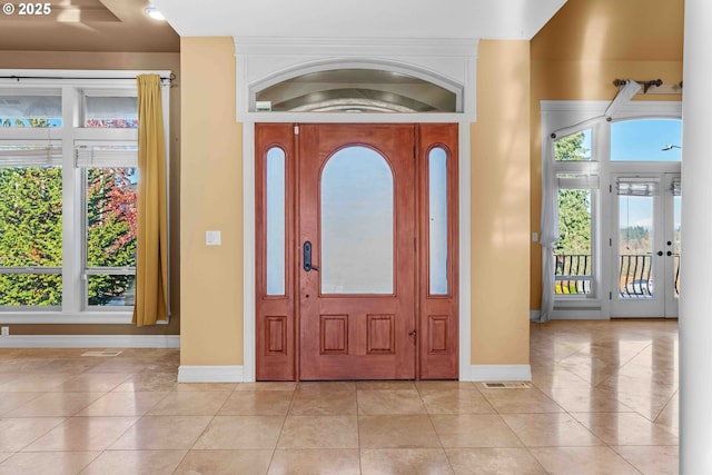 foyer entrance featuring plenty of natural light and light tile patterned floors