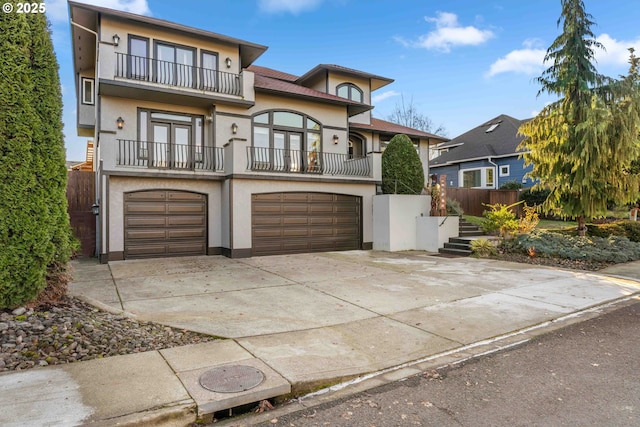 view of front of property featuring a balcony and a garage