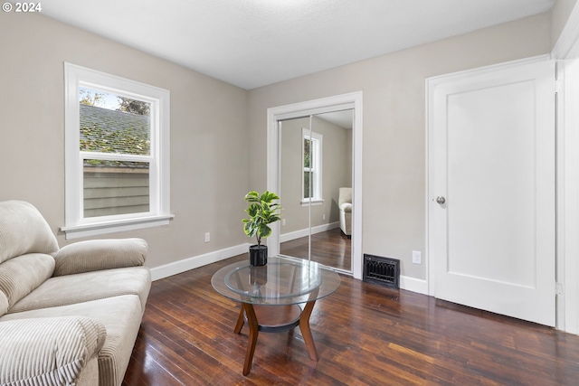 sitting room with dark hardwood / wood-style flooring and plenty of natural light