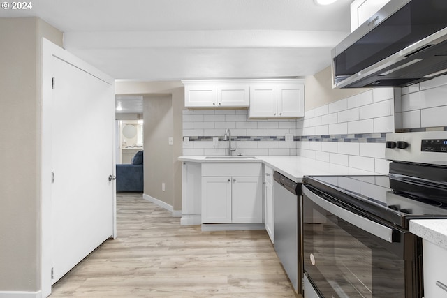 kitchen featuring stainless steel appliances, backsplash, white cabinetry, and sink