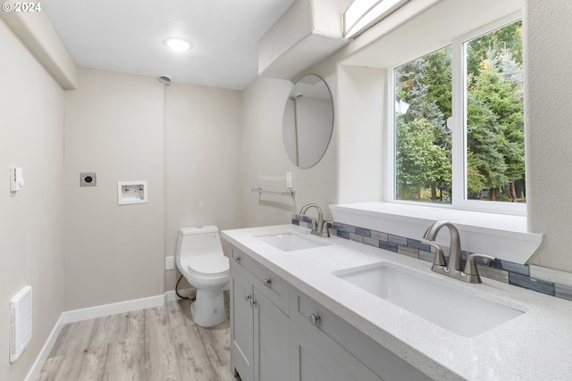 bathroom featuring toilet, vanity, and hardwood / wood-style flooring