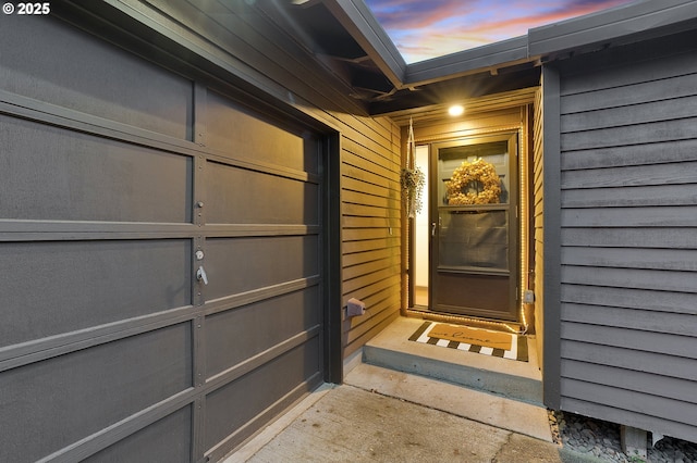 exterior entry at dusk with a garage