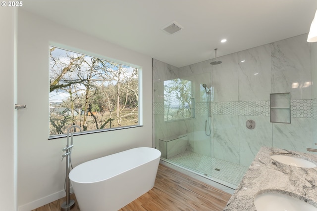 bathroom with hardwood / wood-style flooring, vanity, and independent shower and bath