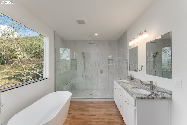 bathroom featuring hardwood / wood-style flooring, vanity, plenty of natural light, and shower with separate bathtub