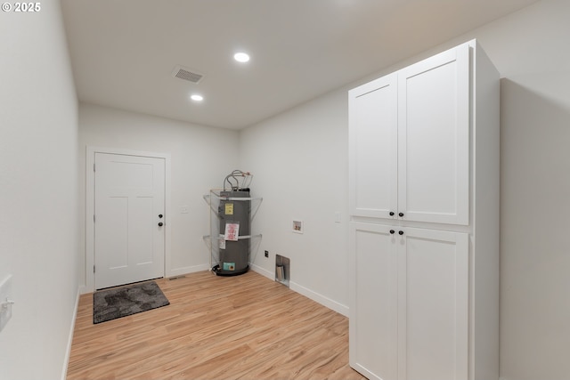 entryway featuring electric water heater and light wood-type flooring