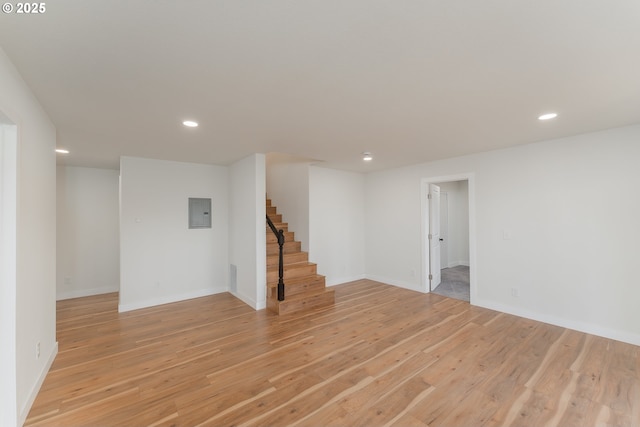 interior space with electric panel and light hardwood / wood-style flooring