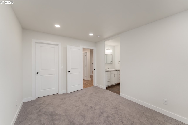 125 Sylvan Vista Ct, Roseburg, OR 97471 - unfurnished bedroom with dark carpet, baseboards, recessed lighting, a sink, and connected bathroom