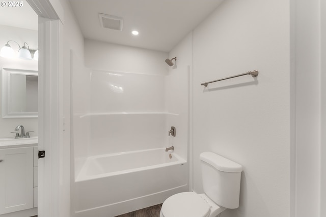 full bathroom with hardwood / wood-style floors, vanity, toilet, and shower / tub combination