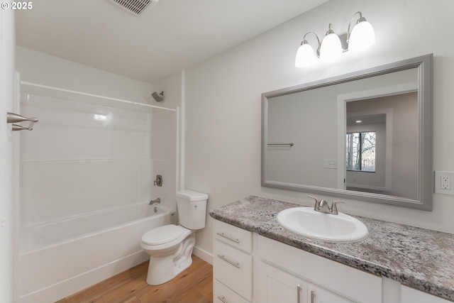 full bathroom with vanity, toilet, wood-type flooring, and bathing tub / shower combination