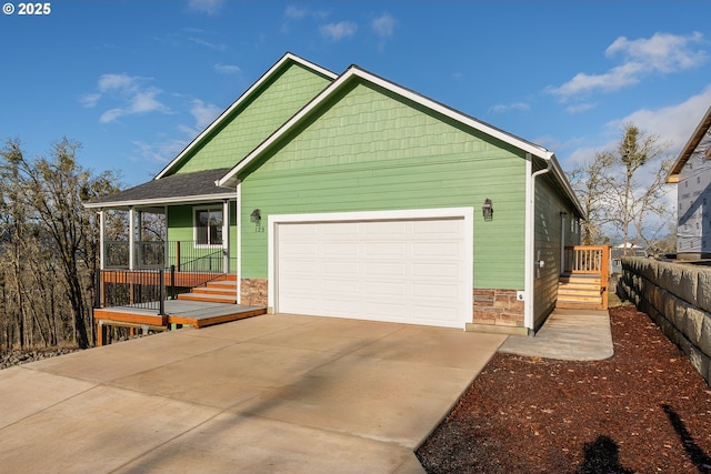 125 Sylvan Vista Ct, Roseburg, OR 97471 - view of front of home with stone siding, concrete driveway, and an attached garage