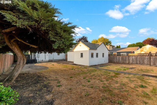 2849 Florida St, Longview, WA 98632 - fenced backyard featuring entry steps, an outbuilding, and a patio