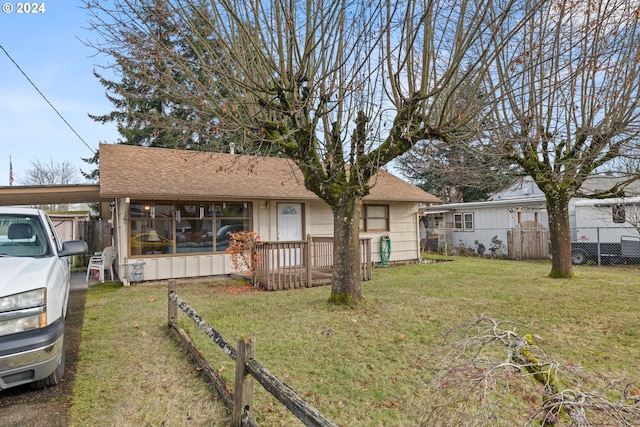 view of front facade with a carport and a front yard