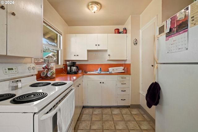 kitchen with white cabinetry, white appliances, and sink