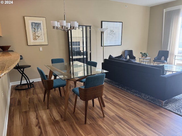 dining space featuring hardwood / wood-style floors and a notable chandelier