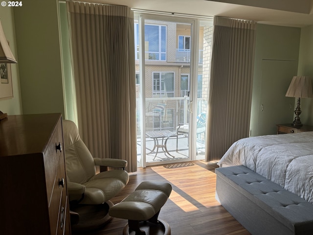 bedroom featuring hardwood / wood-style flooring and access to exterior