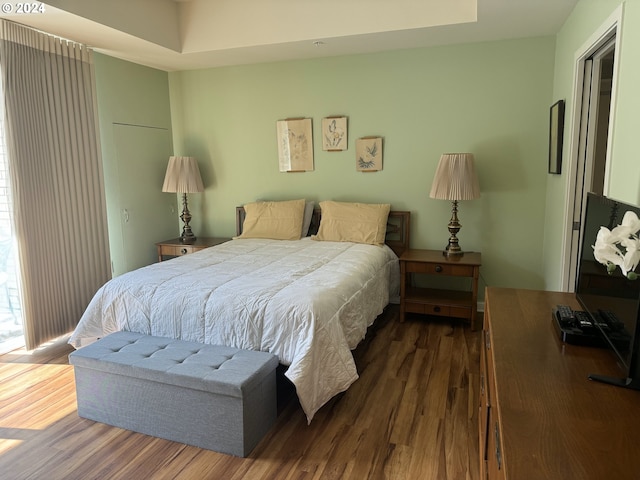 bedroom with dark hardwood / wood-style flooring