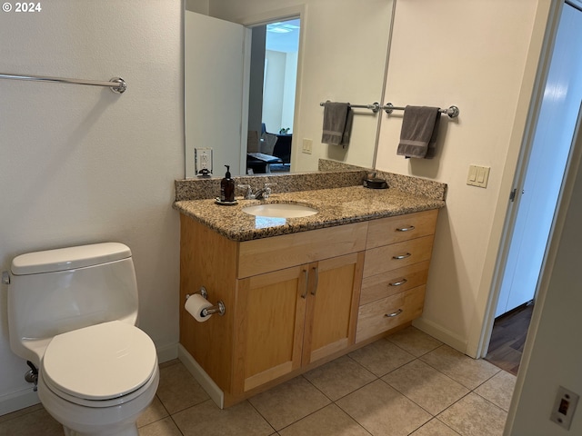 bathroom with vanity, tile patterned floors, and toilet