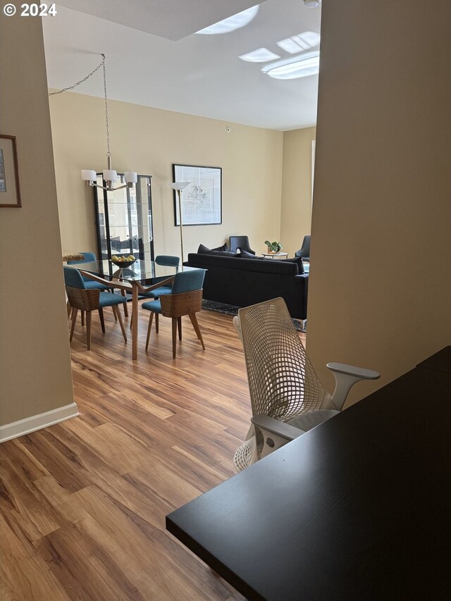 dining area with an inviting chandelier and wood-type flooring