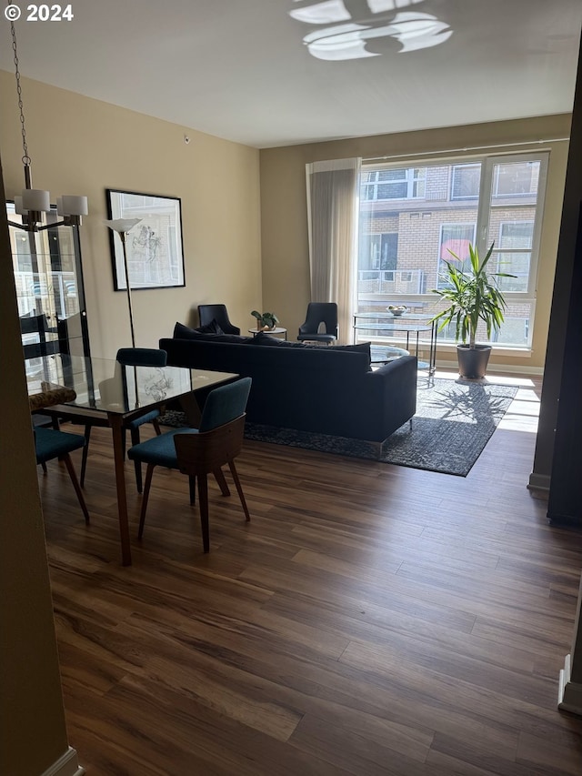 living room featuring dark hardwood / wood-style flooring and a chandelier