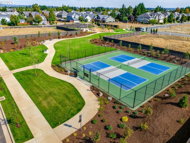 view of tennis court with a lawn