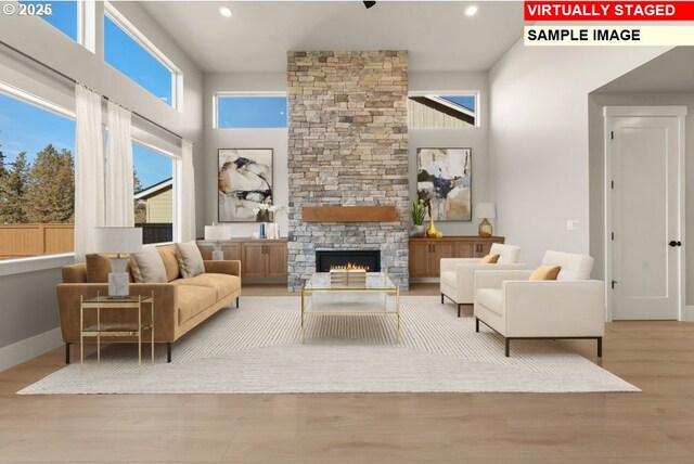 kitchen with a kitchen bar, light hardwood / wood-style floors, a center island with sink, and appliances with stainless steel finishes